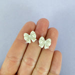 Load image into Gallery viewer, Bow Stud Earrings in Shimmery Pearl

