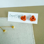 Load image into Gallery viewer, Knot Stud Earrings in Pumpkin Orange
