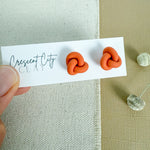 Load image into Gallery viewer, Knot Stud Earrings in Pumpkin Orange
