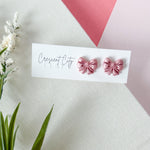 Load image into Gallery viewer, Bow Studs in Shimmery Pink (child)
