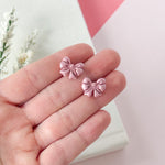 Load image into Gallery viewer, Bow Studs in Shimmery Pink (child)
